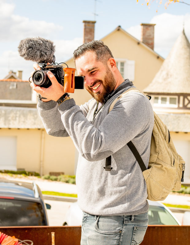 Yohann Partouche en train d'effectuer une prise de vue au sol avec un appareil photo équipé d'un micro et d'un stabilisateur